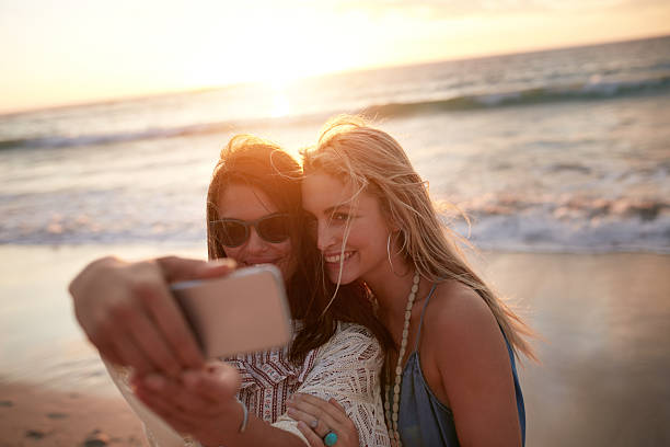 istock Two female friends taking a selfie at the beach 540488390