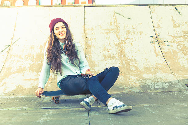 istock Hipster skateboarder girl with skateboard outdoor at skatepark 540489590