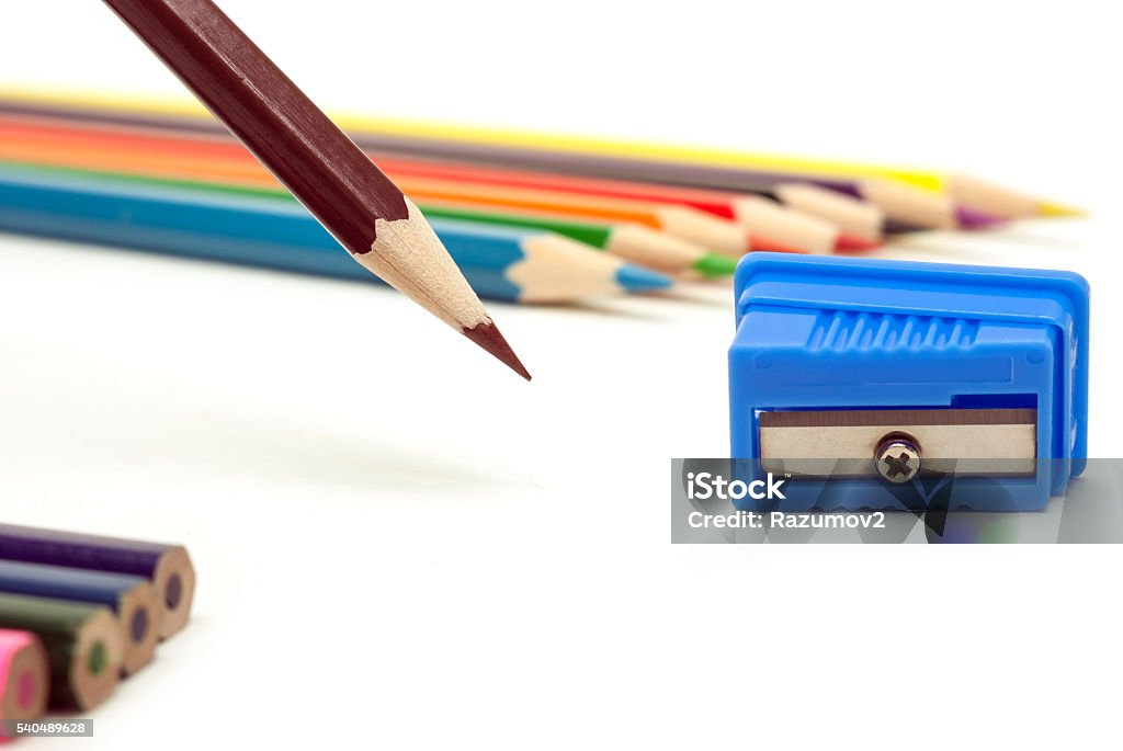 brown pencil brown pencil and a blue pencil sharpener on a white background Equipment Stock Photo