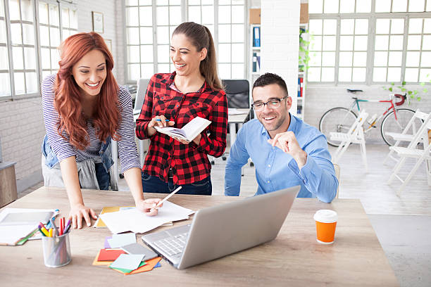istock Three young designers discussing new ideas at workplace 540489950