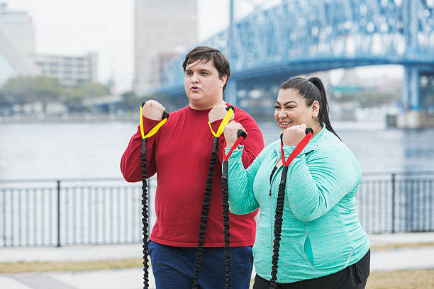 istock Overweight people exercising with resistance bands 540491014
