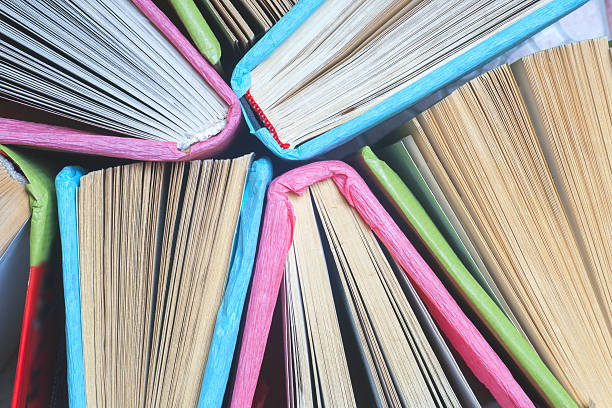 istock Old and used colorful hardback books or text books 540491874