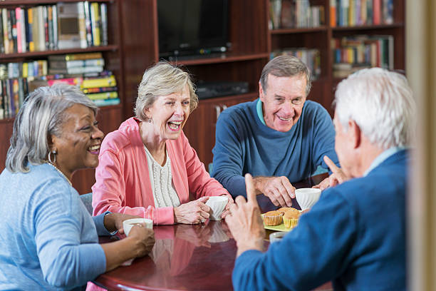 istock Group of seniors conversing, laughing over coffee 540492390