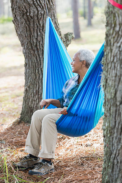 istock Happy senior black woman sitting on hammock 540492848