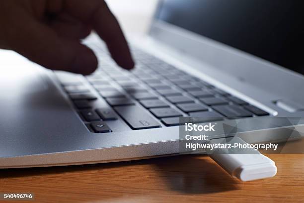 Backing Up Computer Data Onto Memory Stick Stock Photo - Download Image Now - USB Stick, Laptop, USB Port