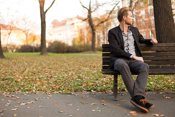 istock Young man on bench at autumn park 540499656