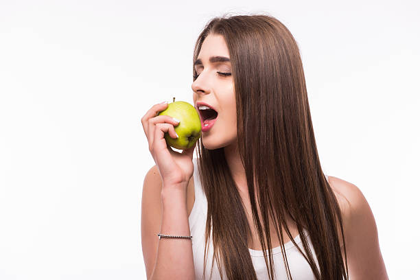 istock woman eat green apple on white 540501064