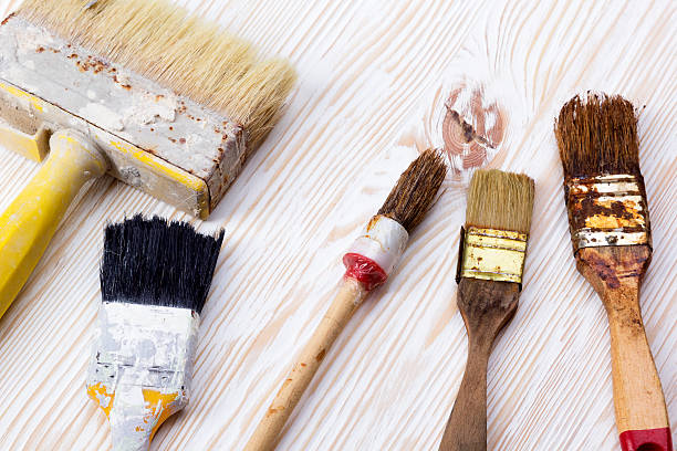 istock paint brushes on wooden background 540503120