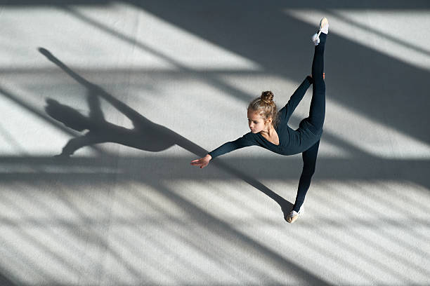 istock little girl doing balance on  rhythmic gymnastics 540504568