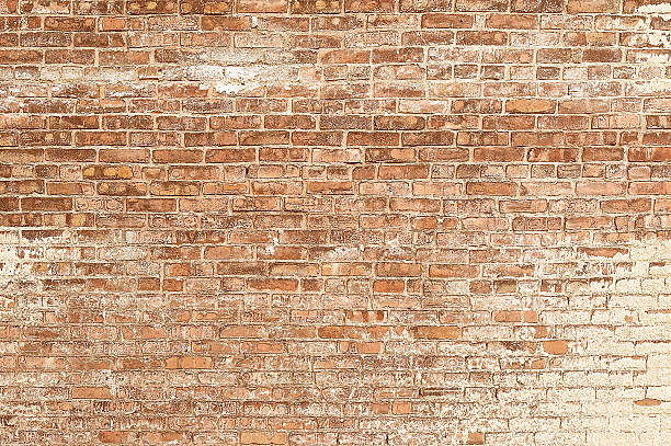 istock Old red brick wall with white paint background texture 540504696