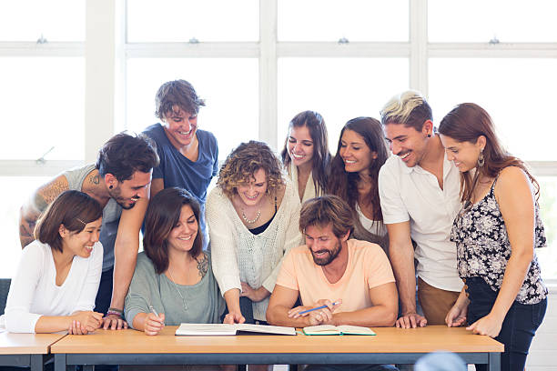 istock Group of Multi-Ethnic Students working with Teacher in Classroom 540504700