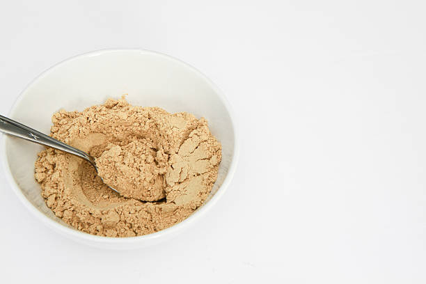 istock Ginger powder in white bowl with spoon, isolated on white 540504914