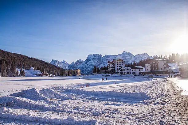 Lake Misurina in the Italian Dolomites in the winter  winter covered with snow. The hotel backed on to the mountains. Close photo of the hotel.