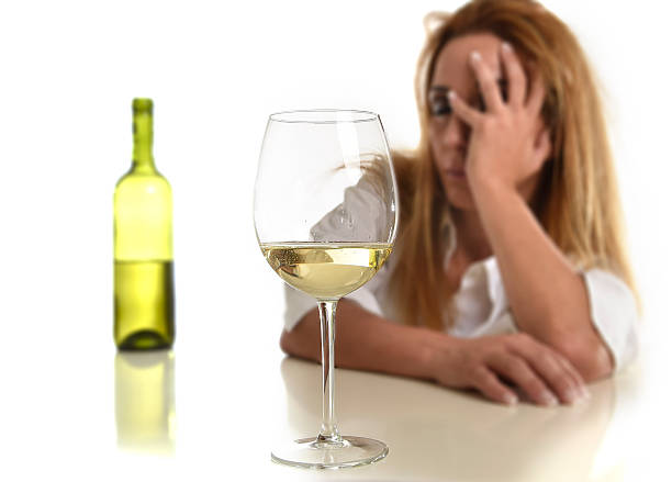 istock blond wasted and depressed alcoholic woman drinking white wine 540506090