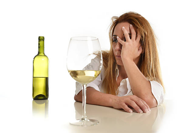 istock blond wasted and depressed alcoholic woman drinking white wine 540506118
