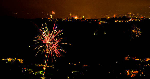 di fuoco d "artificio in città, al buio. - firework display pyrotechnics celebration fourth of july foto e immagini stock