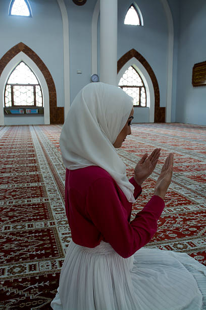istock Young muslim woman praying in mosque 540510128