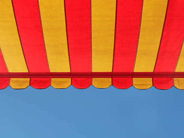 istock colorful stripe canopy awning isolated against clear blue sky 540510596