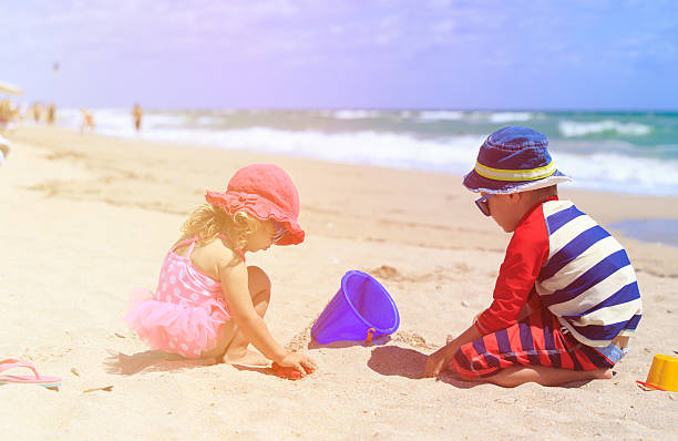 istock kids play with sand on summer beach 540510862