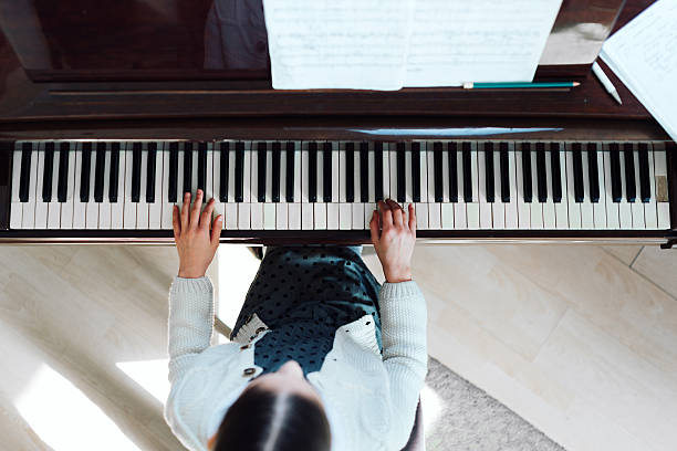 istock girl playing on  grand piano, top view 540511004