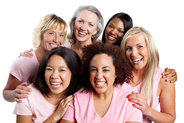 Happy group of women in pink all embracing each other. Isolated on white.