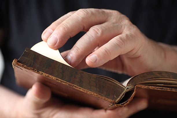 istock Older man looks at vintage book 540513810
