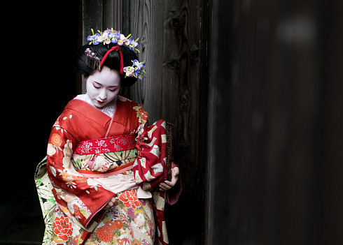 Portrait of a Geisha wearing a beautiful kimono and traditional  clothing - Japanese culture