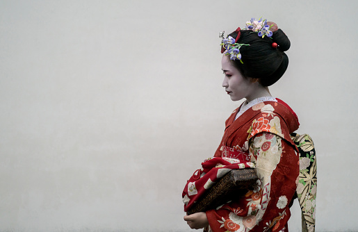 Portrait of a beautiful Geisha wearing a kimono - Japanese culture