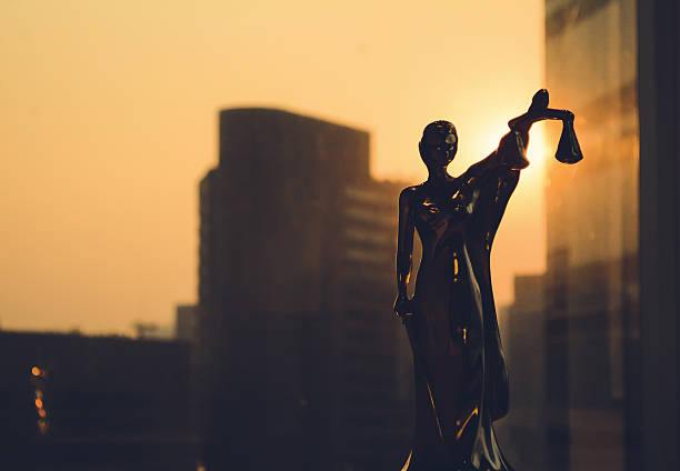 Silhouette of Themis with building background
