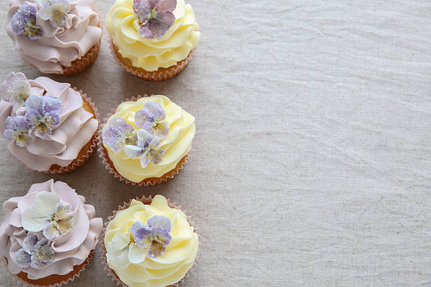 istock Purple and yellow cupcakes with sugared edible flowers 540515588