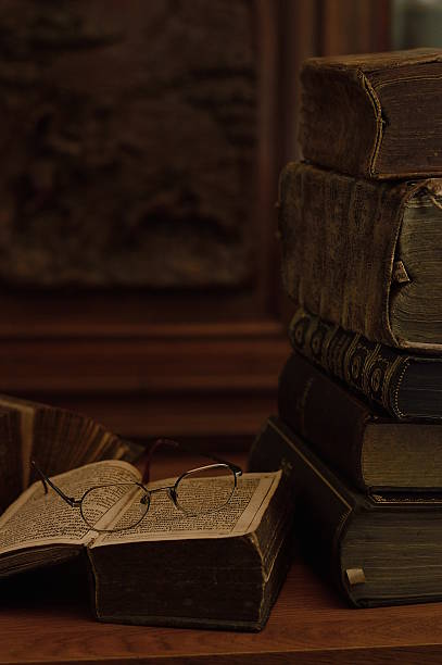 istock antique books with reading glasses 540521070