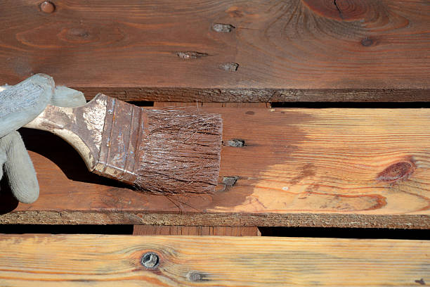 istock Paintbrush with brown paint on planks 540521580