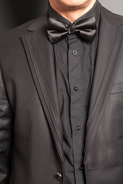 istock Man wearing a black suit and bow tie 540521620
