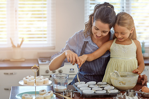 Cropped shot of a mother and her daughter baking in the kitchen