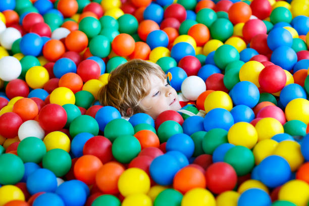 istock child playing at colorful plastic balls playground 540524050