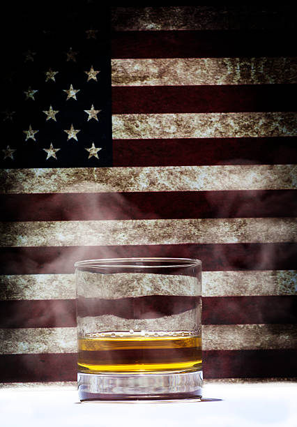 istock Whiskey glass against a striped background with smoke 540524608