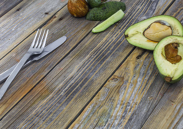 fresh avocado cut on wooden background, food