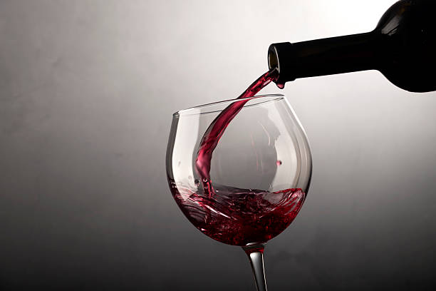 istock Red wine pouring into wine glass 540527290