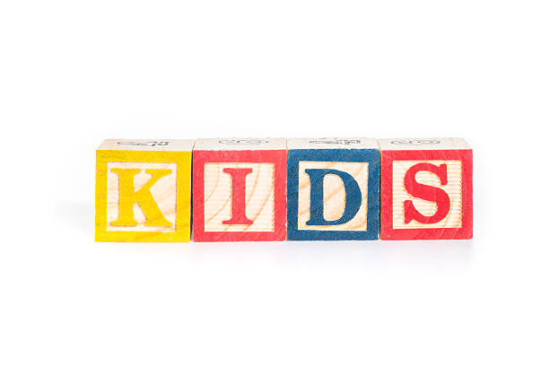 istock KIDS with colorful alphabet blocks on white background 540527928