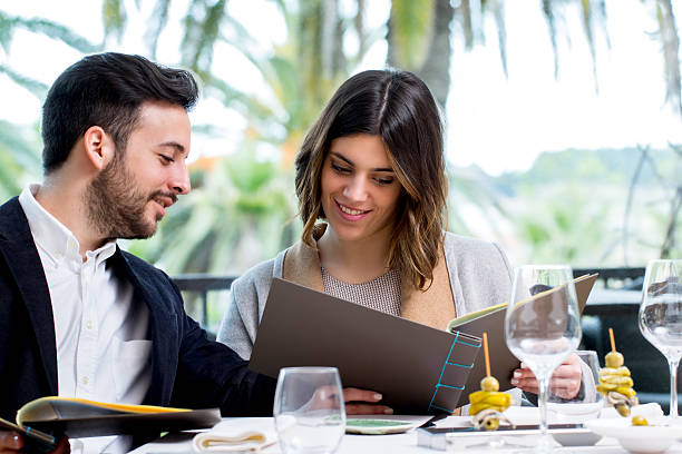 istock Young couple looking at menu in restaurant. 540528302