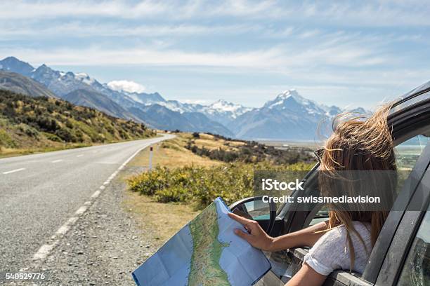 Portrait Of Young Woman In Car Looking At Map Stock Photo - Download Image Now - Car, Road Trip, New Zealand