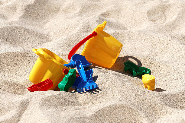 istock Plastic colored toys in the sand 540529802