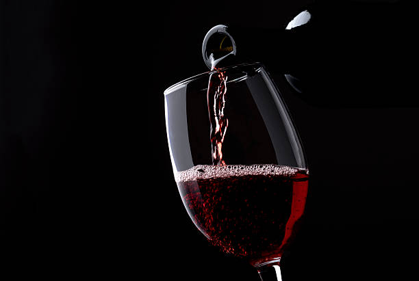 istock Red wine poured into glass 540530506