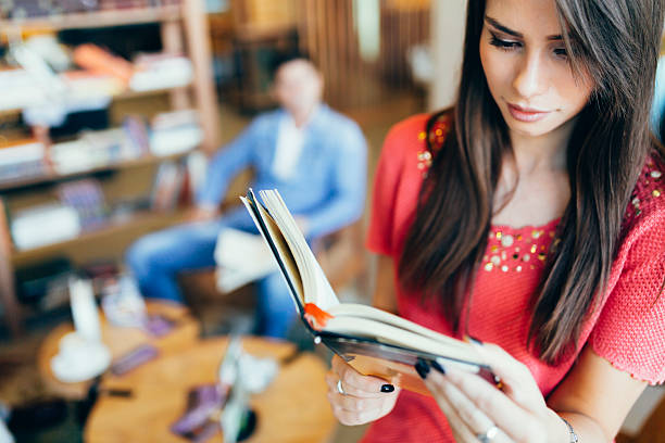 istock Beautiful woman reading book 540530866