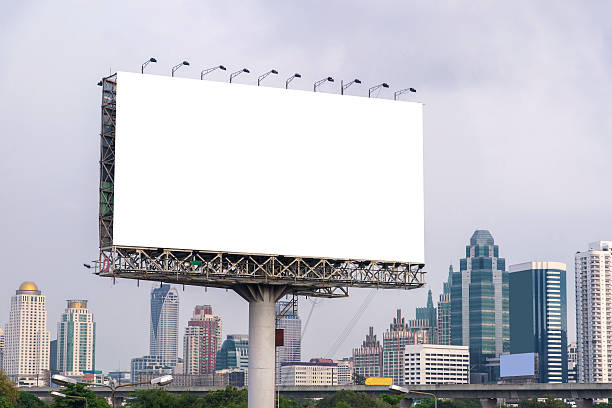 istock large blank billboard on road with city view background 540530906