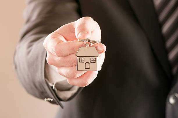 istock Real estate man  holding house keys 540532704