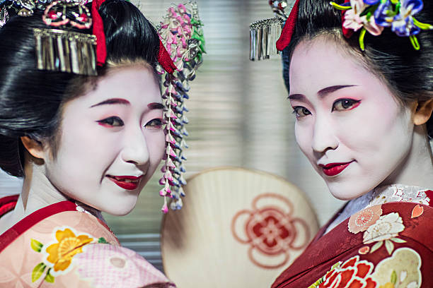Portrait of two beautiful maikos Portrait of two beautiful maikos in Kyoto. geta sandal photos stock pictures, royalty-free photos & images