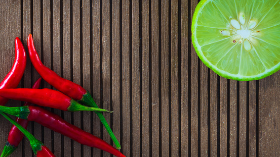 Lemon and red pepper composition. Backdrop Wooden