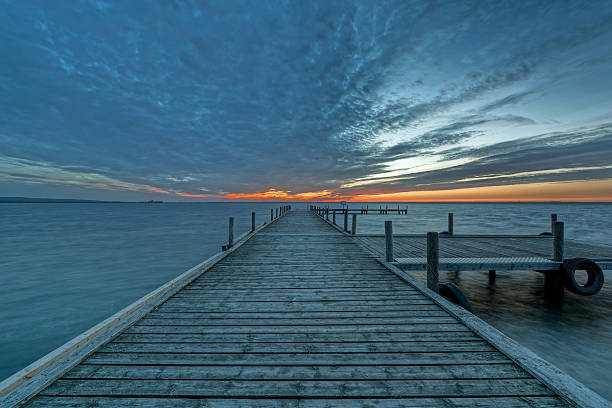 istock Jetty on lake with majestic cloudscape at sunset 540564404