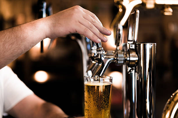 Man getting beer from a beer tap in a pub in Osaka, Japan